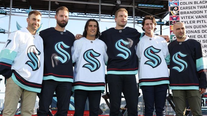 Seattle Kraken forwards Jordan Eberle and Brandon Tanev with their new teammates following the 2021 NHL Expansion Draft, July 21, 2021 in Seattle, Washington.