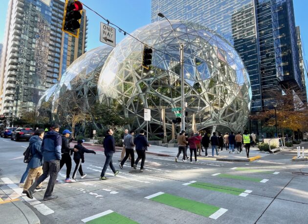 Amazon workers and others near The Spheres on the company’s Seattle headquarters campus last fall. (GeekWire Photo / Kurt Schlosser)